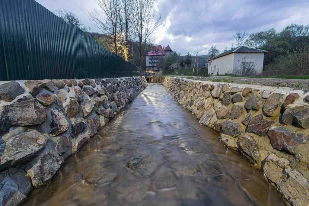 Add a small bridge or stepping stones